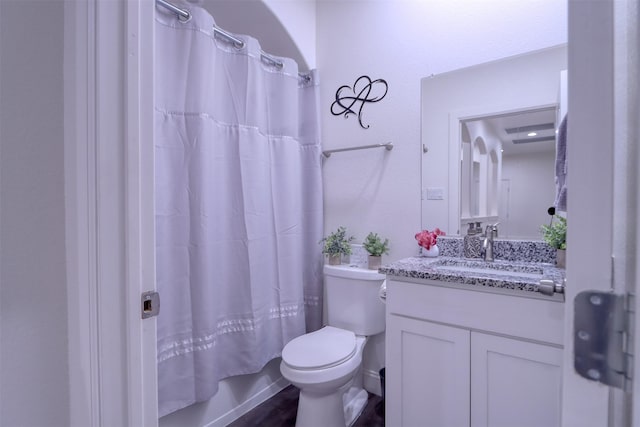 full bathroom with hardwood / wood-style flooring, vanity, toilet, and shower / bath combo with shower curtain