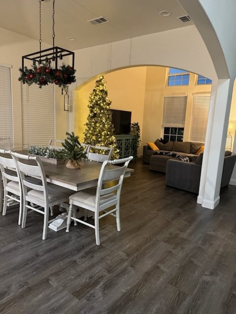 dining room with dark hardwood / wood-style floors and a notable chandelier