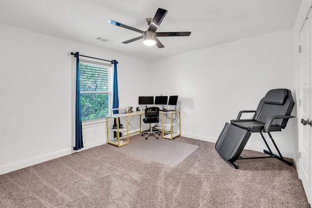 home office with a ceiling fan, baseboards, visible vents, and carpet