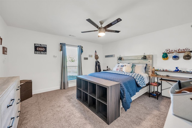 bedroom featuring ceiling fan, visible vents, light carpet, and baseboards