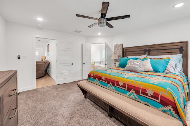 carpeted bedroom with ceiling fan and connected bathroom