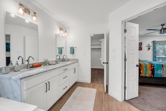 bathroom with vanity, hardwood / wood-style flooring, and ceiling fan