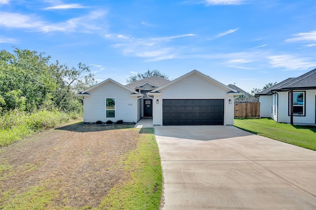 ranch-style home with fence, driveway, a front lawn, and a garage
