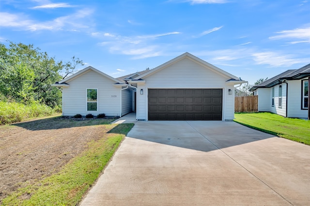 ranch-style home featuring a front yard and a garage