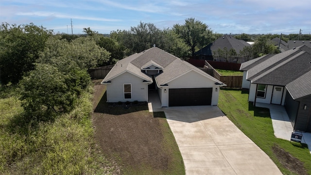 view of front of property featuring a front yard and a garage