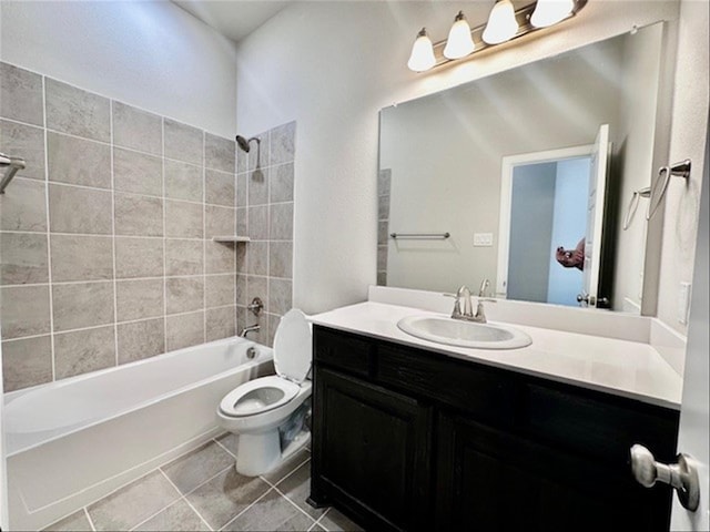 full bathroom featuring tile patterned flooring, vanity, toilet, and tiled shower / bath