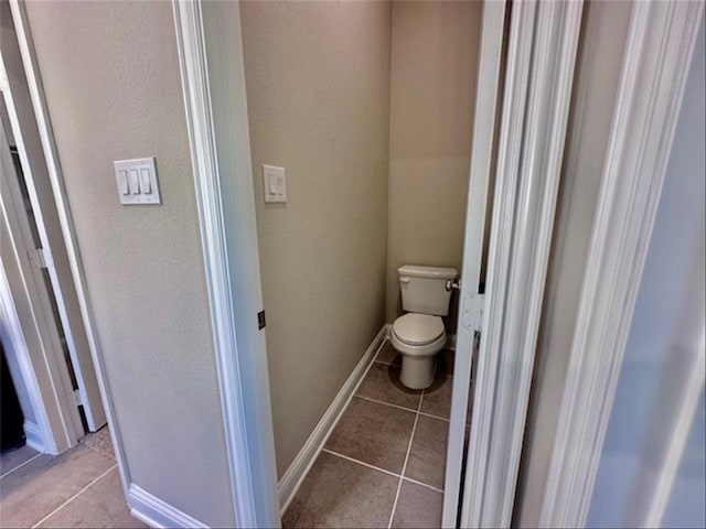 bathroom with tile patterned flooring and toilet