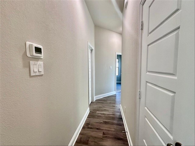 corridor with dark wood-type flooring