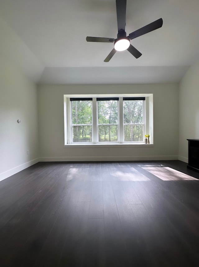 unfurnished living room featuring lofted ceiling, ceiling fan, and dark hardwood / wood-style flooring