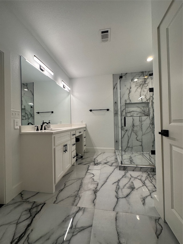 bathroom featuring an enclosed shower, a textured ceiling, and vanity