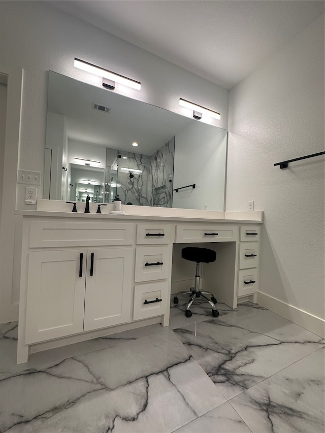 bathroom featuring walk in shower and vanity