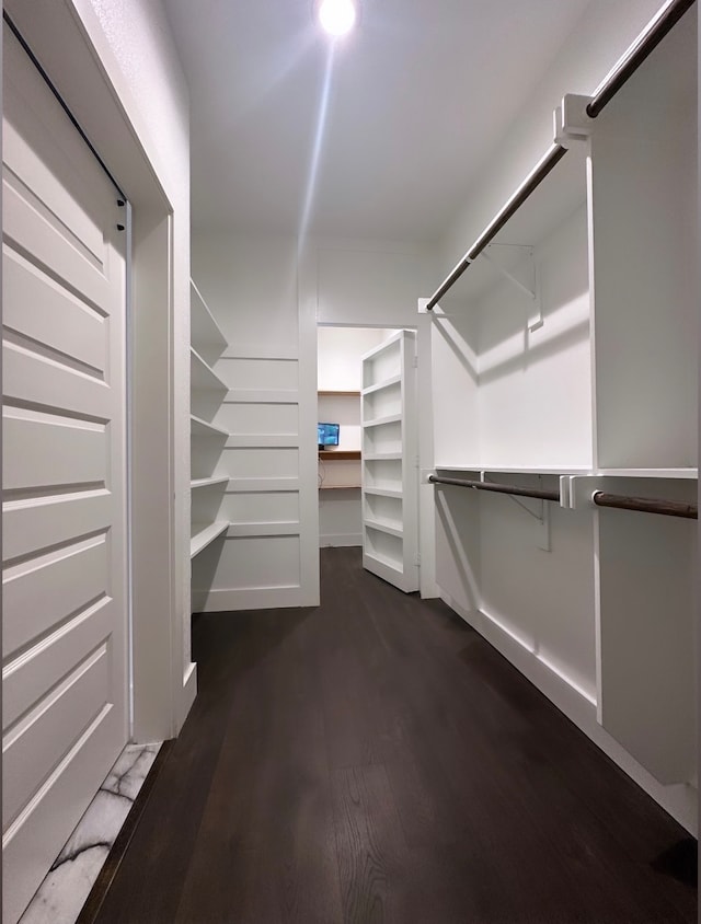 walk in closet with hardwood / wood-style floors