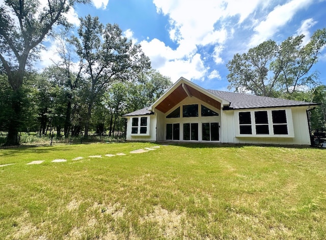 rear view of property featuring a yard