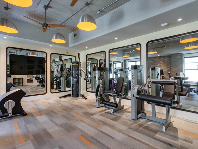 gym featuring ceiling fan and carpet