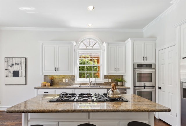 kitchen with a center island, stainless steel appliances, and stone countertops