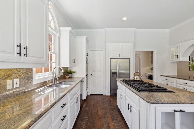 kitchen with light stone countertops, gas stovetop, sink, built in refrigerator, and dark hardwood / wood-style floors