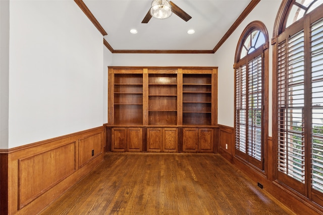 unfurnished office featuring ceiling fan, dark hardwood / wood-style floors, and crown molding