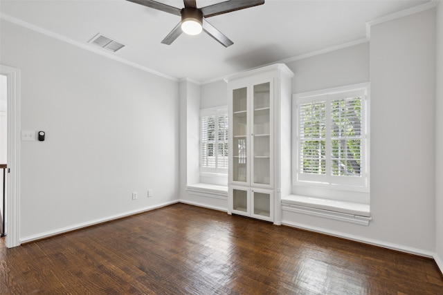 spare room featuring crown molding, dark hardwood / wood-style flooring, and ceiling fan