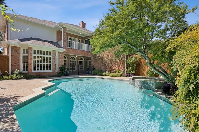 view of pool with an in ground hot tub and a patio