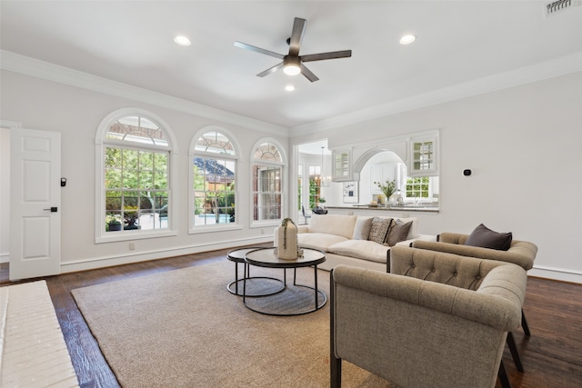 living room with dark wood-type flooring, ceiling fan, and ornamental molding