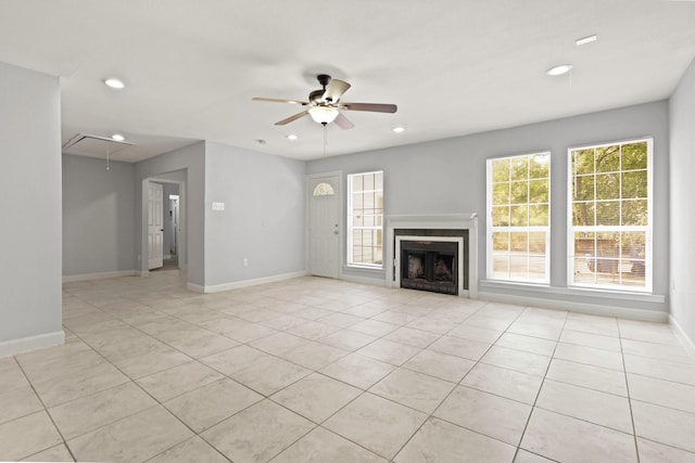 unfurnished living room featuring light tile patterned floors, ceiling fan, and a healthy amount of sunlight