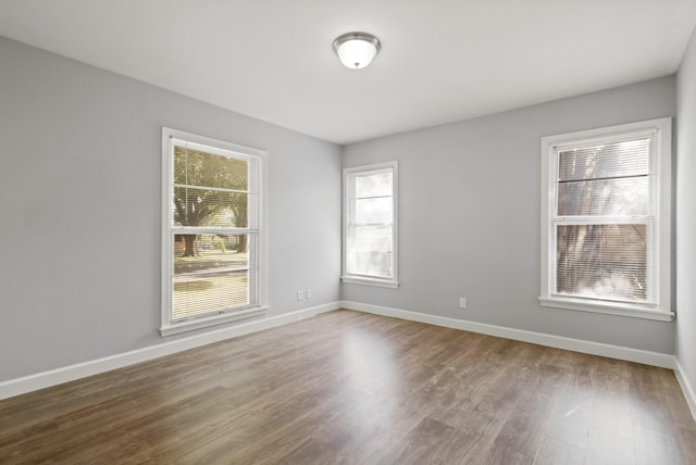 spare room with hardwood / wood-style floors