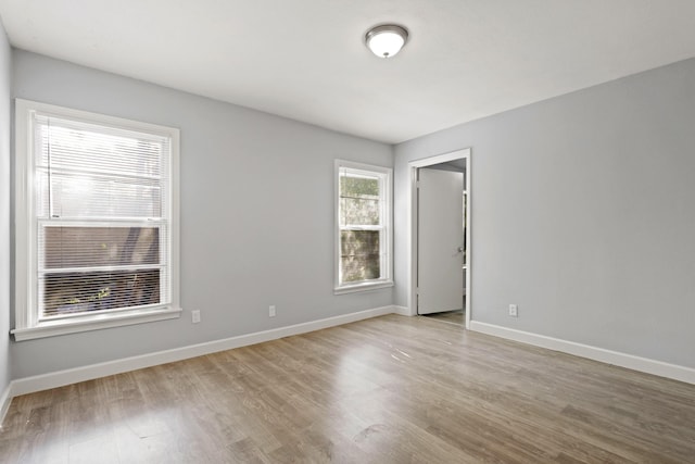 spare room with light hardwood / wood-style flooring