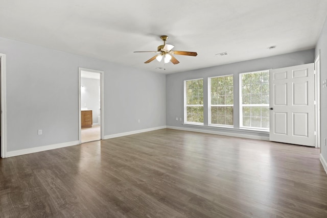 empty room featuring dark hardwood / wood-style floors and ceiling fan