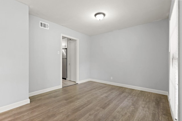 spare room with hardwood / wood-style flooring