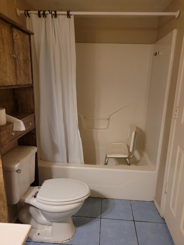 full bathroom featuring vanity, toilet, tile patterned flooring, and shower / bathtub combination with curtain