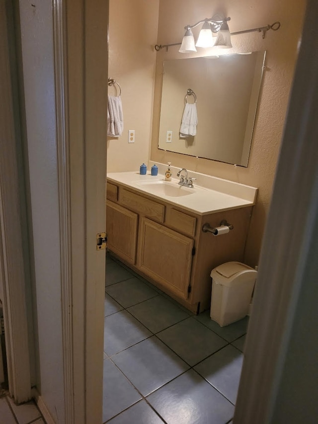 bathroom featuring tile patterned floors, toilet, and vanity