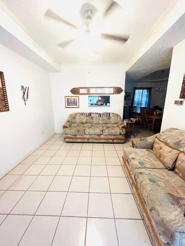 tiled living room with a textured ceiling and ceiling fan