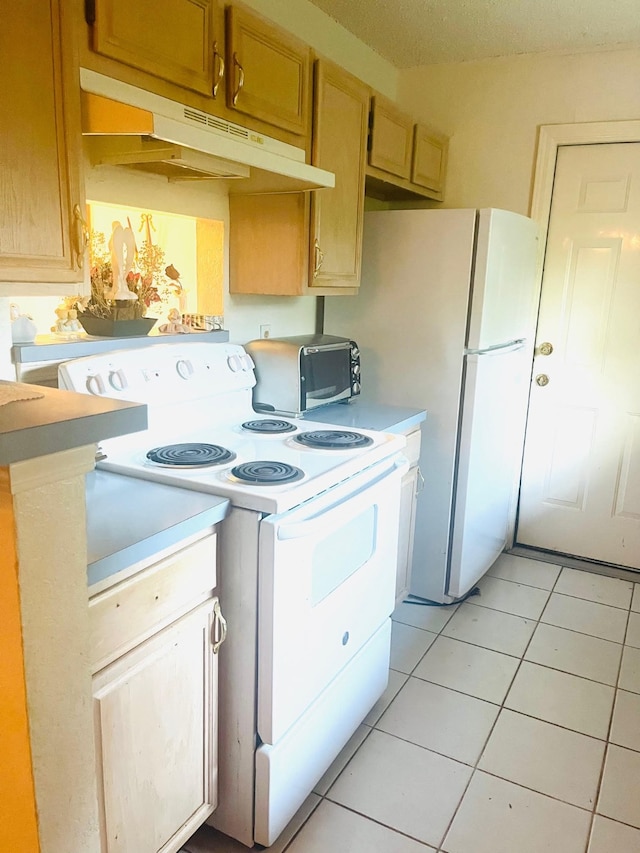 kitchen with white range with electric cooktop and light tile patterned floors