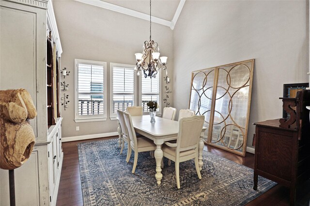 dining space with dark hardwood / wood-style floors, an inviting chandelier, lofted ceiling, and crown molding