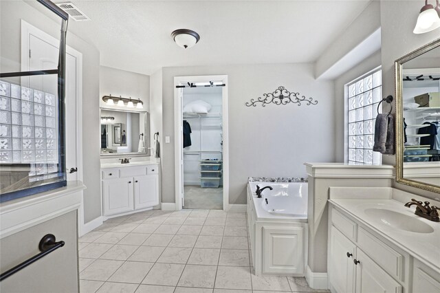 bathroom featuring tile patterned flooring, vanity, and a bathtub