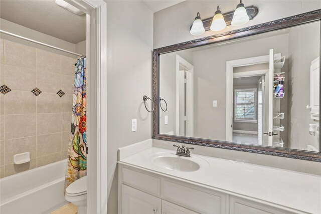 full bathroom featuring vanity, toilet, and shower / tub combo with curtain