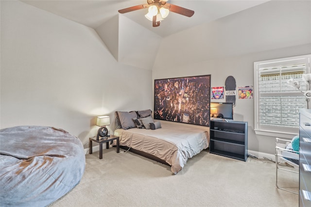 carpeted bedroom featuring ceiling fan and vaulted ceiling