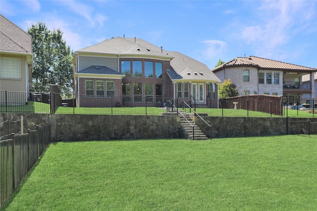 rear view of house with a lawn