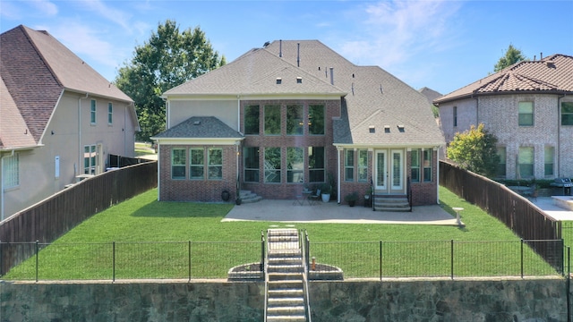 back of property featuring french doors, a patio area, and a lawn