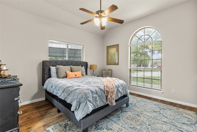 bedroom with multiple windows, ceiling fan, dark hardwood / wood-style flooring, and vaulted ceiling