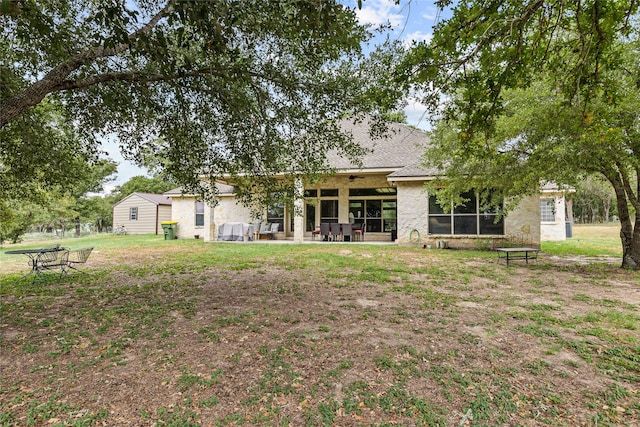 rear view of property featuring a patio area