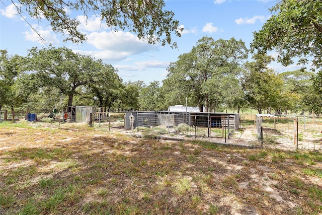 view of yard with an outdoor structure and a rural view