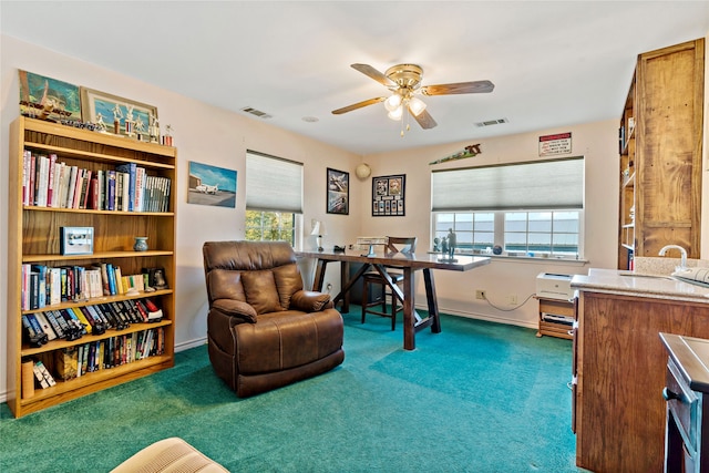 office featuring dark carpet and ceiling fan