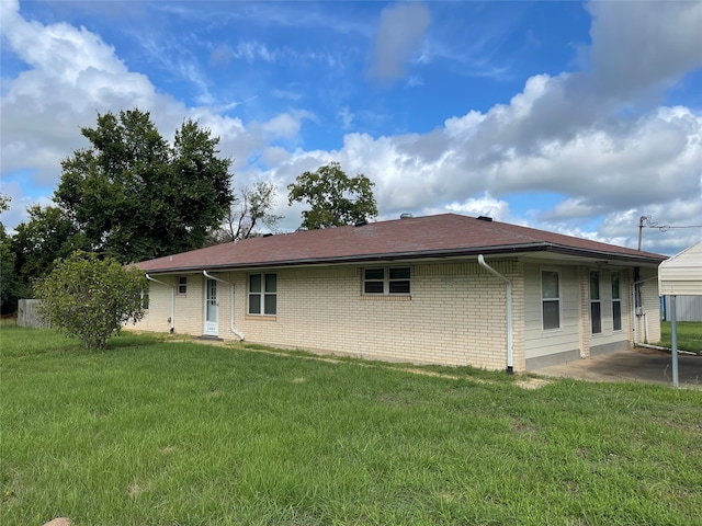 back of property with a lawn