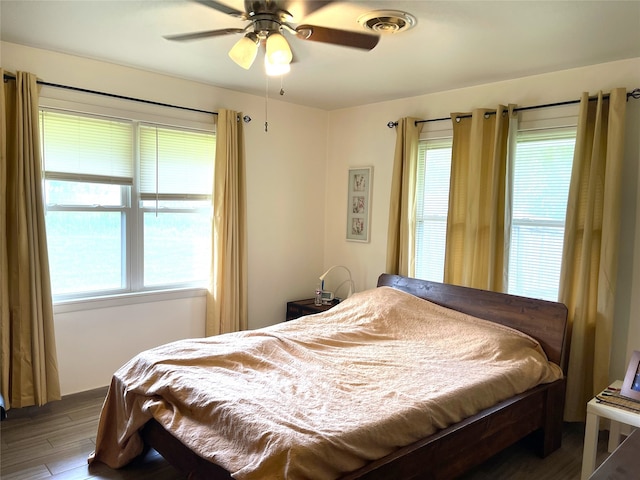 bedroom with ceiling fan and hardwood / wood-style flooring