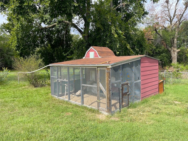 view of outbuilding featuring a yard