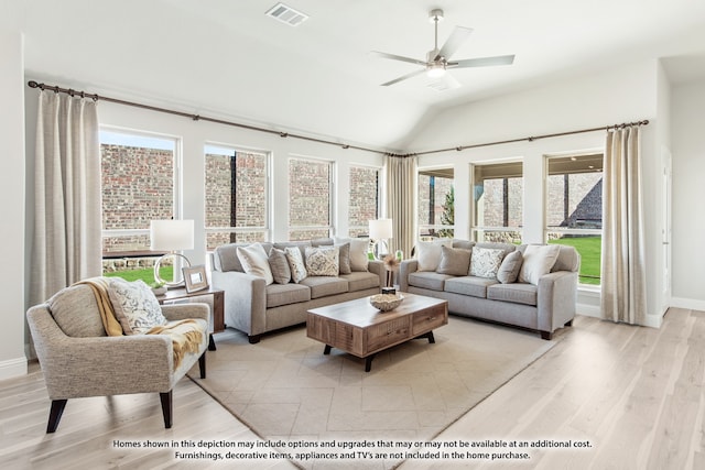 living room with lofted ceiling, ceiling fan, plenty of natural light, and light hardwood / wood-style flooring