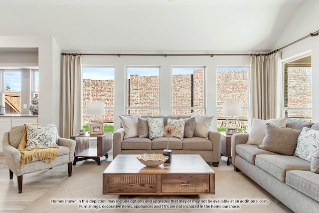 living room with vaulted ceiling, a healthy amount of sunlight, and light tile patterned floors