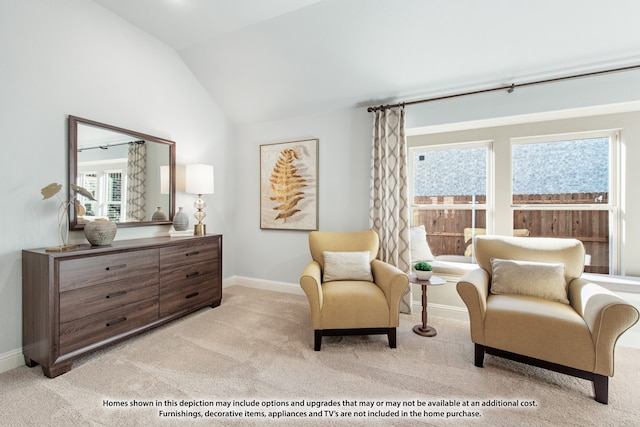 living area featuring lofted ceiling and light carpet