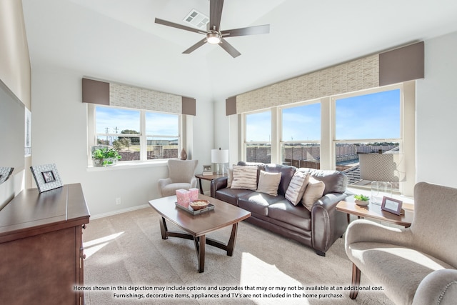 living room featuring light carpet, plenty of natural light, and ceiling fan